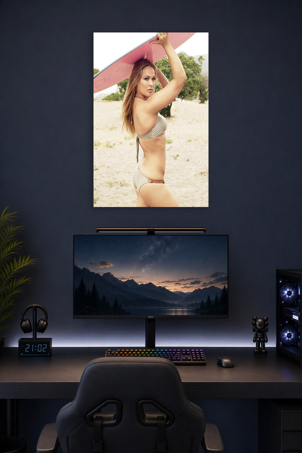 Ronda Rousey in a gaming desk setup above a monitor.