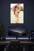 Ronda Rousey in a gaming desk setup above a monitor.