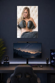Ronda Rousey in a gaming desk setup above a monitor.