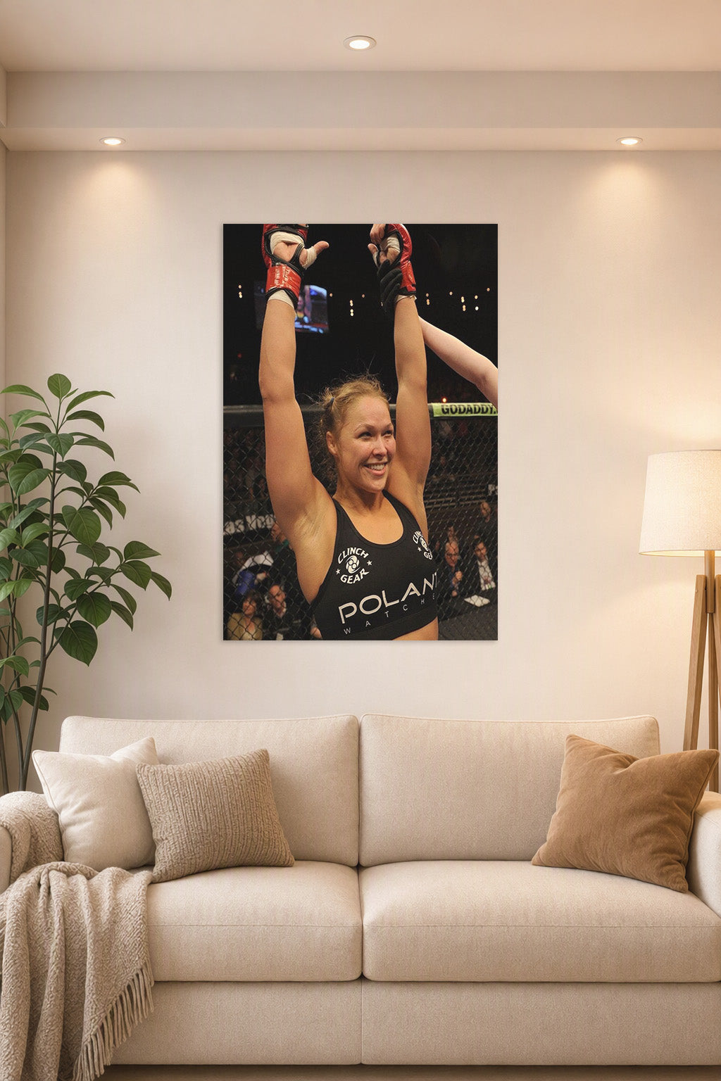 Ronda Rousey in a bright living room above a beige sofa.