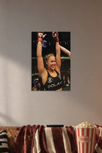 Ronda Rousey in a cozy movie room above a brown sofa with popcorn.