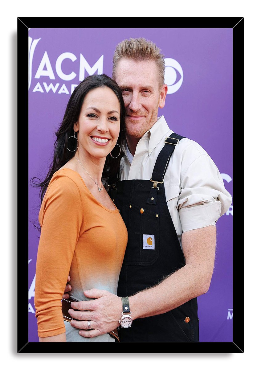Rory and Joey Feek framed wall art print portrays the smiling couple embracing, set against a purple ACM Awards backdrop.