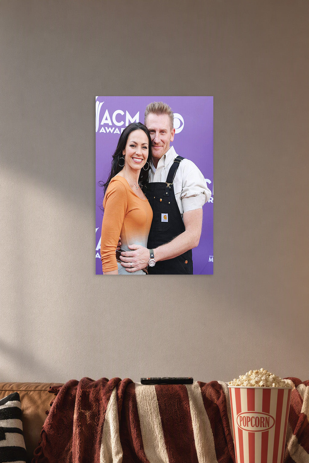 Rory and Joey Feek in a cozy movie room above a brown sofa with popcorn.