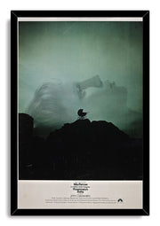 Rosemary's Baby framed wall art print presents a green-tinted woman’s profile and baby carriage silhouette over a black rocky landscape.