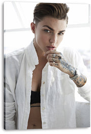 Ruby Rose canvas wall art print presents a bright close portrait of her in an open white shirt with tattooed hand and jewelry.