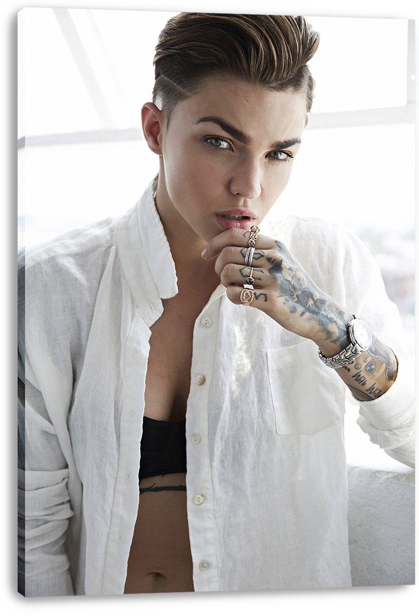 Ruby Rose canvas wall art print presents a bright close portrait of her in an open white shirt with tattooed hand and jewelry.