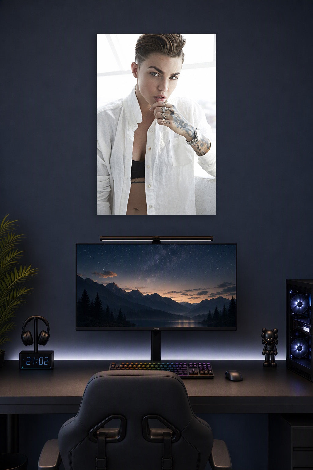 Ruby Rose in a gaming desk setup above a monitor.