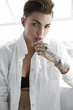 Ruby Rose wall art print features a close portrait in a white shirt, with tattooed hand, rings, and silver watch.
