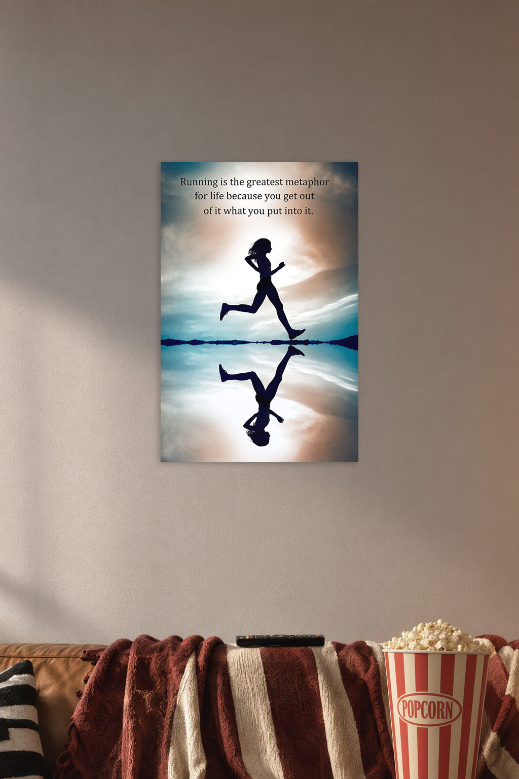 Running Silhouette Motivational Quote in a cozy movie room above a brown sofa with popcorn.