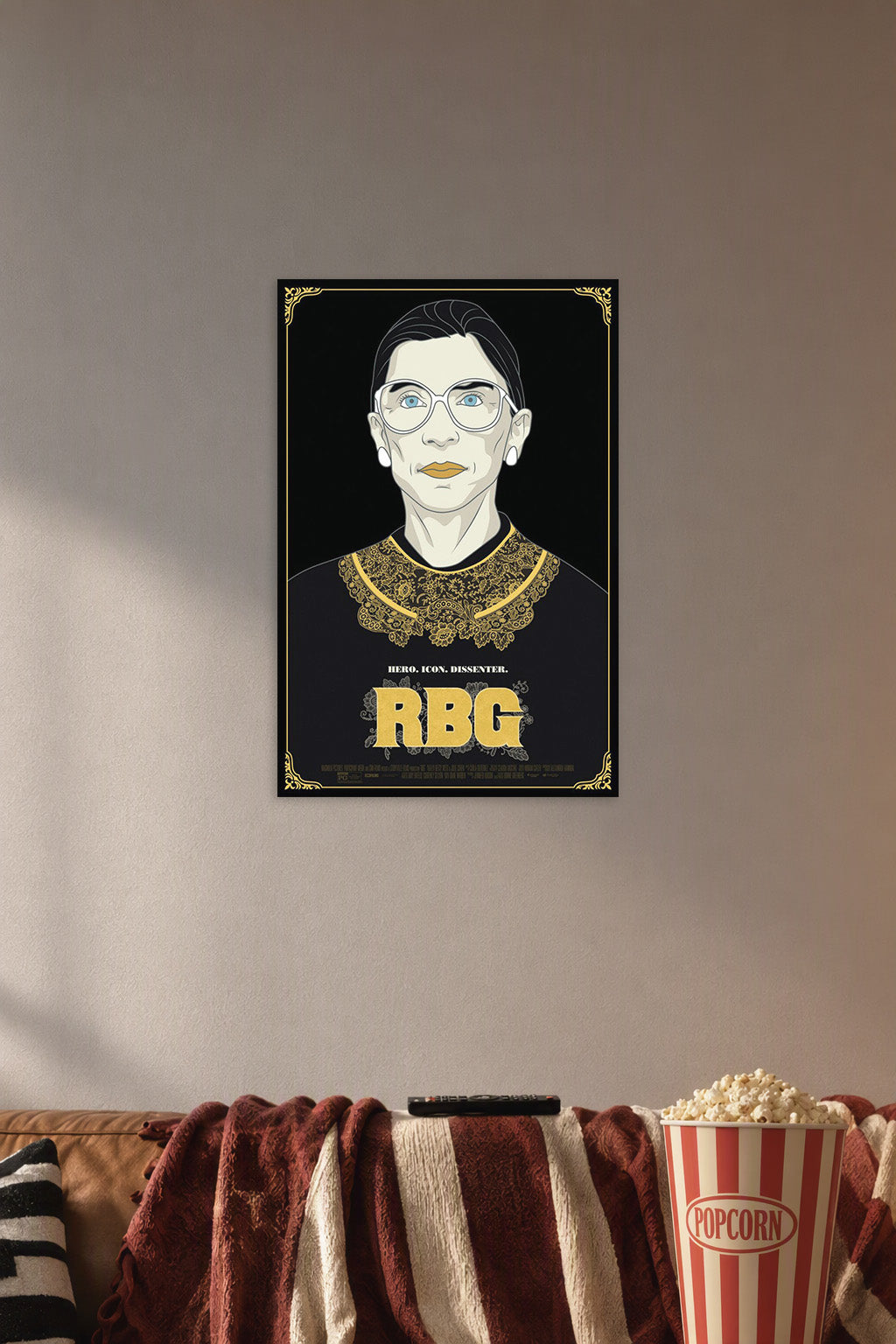 Ruth Bader Ginsburg in a cozy movie room above a brown sofa with popcorn.