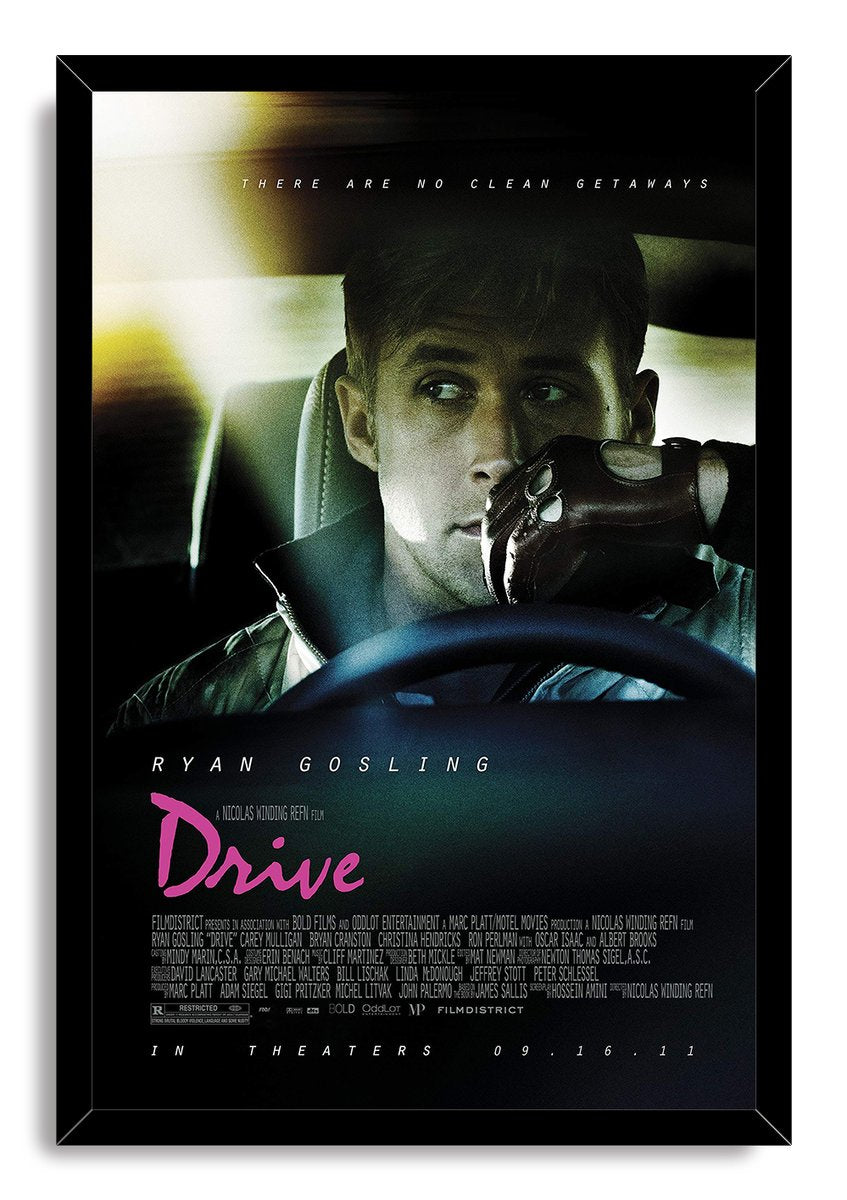 Drive movie poster wall art print in a black frame, featuring Ryan Gosling in a car with a leather glove and pink title text.