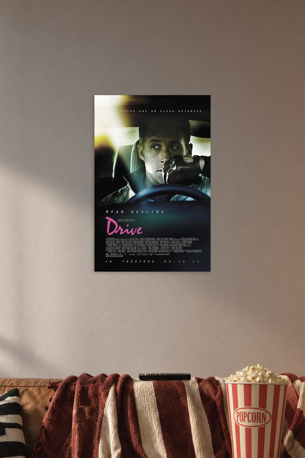 Ryan Gosling Drive Movie in a cozy movie room above a brown sofa with popcorn.