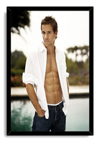 Ryan Reynolds framed wall art print features a poolside portrait, open white shirt and dark jeans in a black frame.
