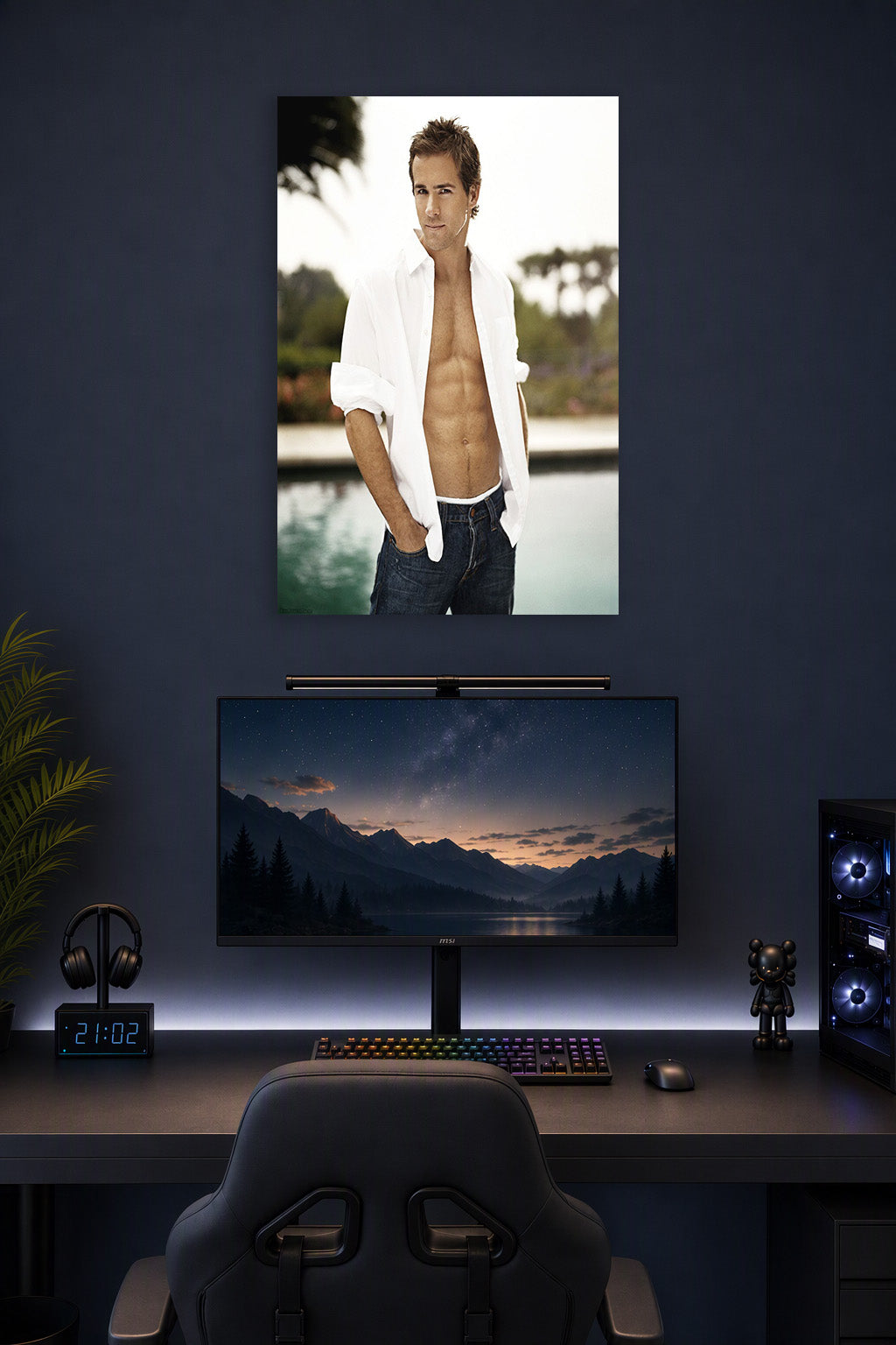 Ryan Reynolds in a gaming desk setup above a monitor.