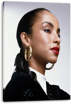 Sade Adu canvas wall art print with a close-up profile portrait, gold hoops, red lips, braided hair, and black clothing.