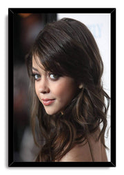 Sarah Hyland framed wall art print featuring a close-up portrait with wavy dark brown hair inside a black border.