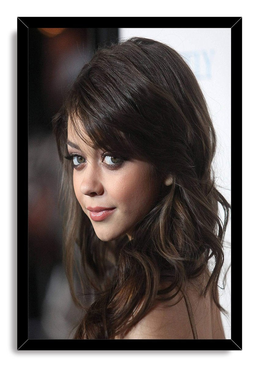 Sarah Hyland framed wall art print featuring a close-up portrait with wavy dark brown hair inside a black border.