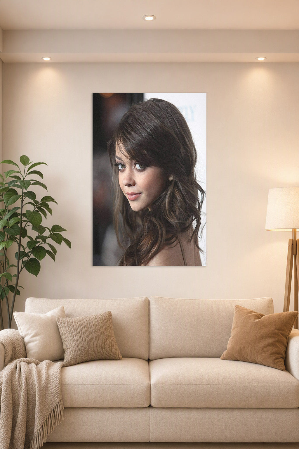 Sarah Hyland in a bright living room above a beige sofa.