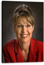Sarah Palin canvas wall art print displays her smiling portrait with glasses, red blazer, and dark gray studio backdrop.