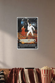 Saturday Night Fever John Travolta in a cozy movie room above a brown sofa with popcorn.