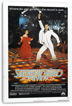 Saturday Night Fever movie poster canvas print featuring a white-suited dancer, a woman in red, sparkling nightclub lights, and bold title lettering.
