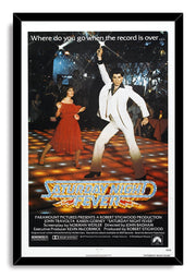 Saturday Night Fever movie poster wall art print in a black frame, with disco dancers under starry lights and the metallic gold-and-blue title.