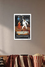 Saturday Night Fever Movie Poster in a cozy movie room above a brown sofa with popcorn.