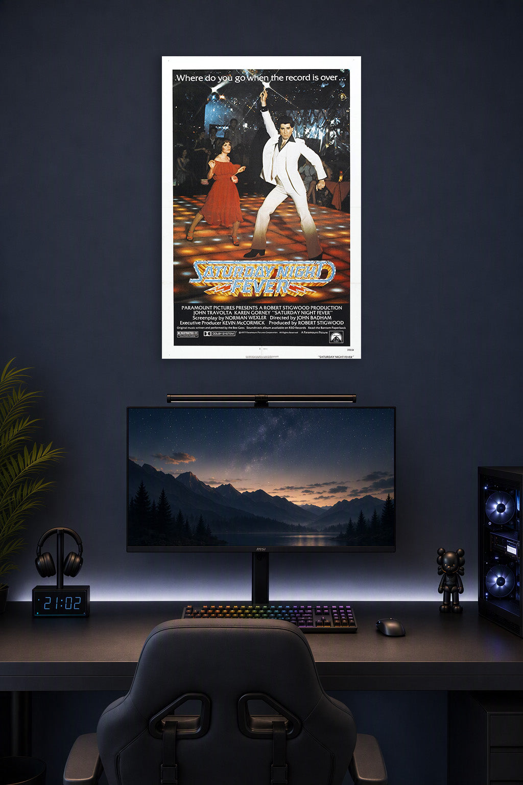 Saturday Night Fever Movie Poster in a gaming desk setup above a monitor.