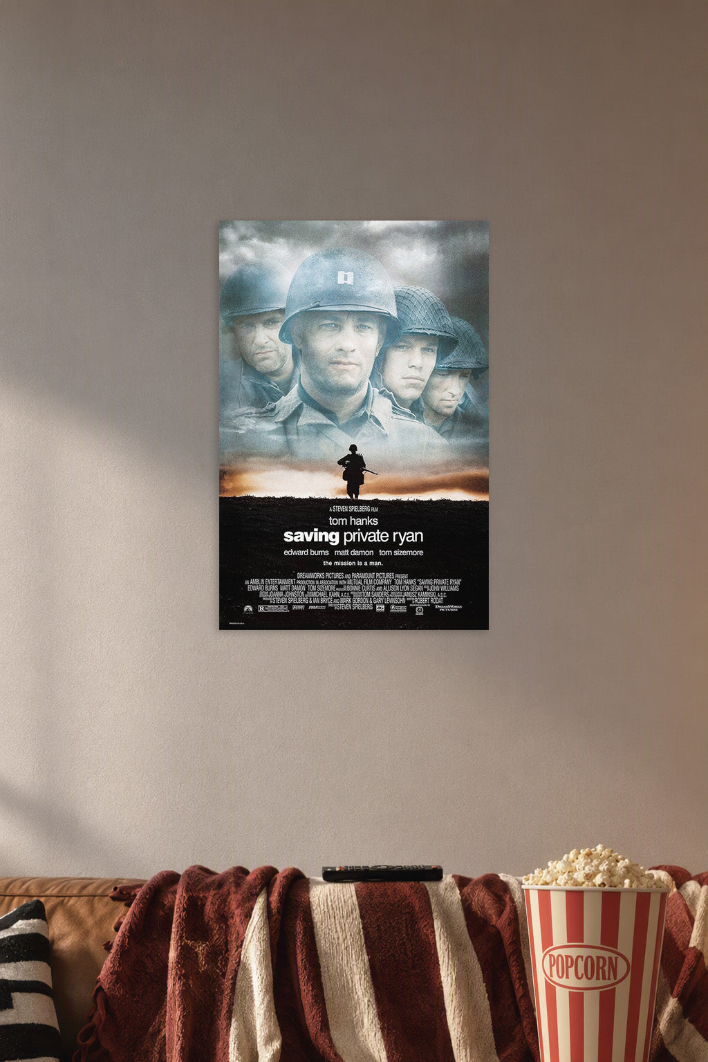 Saving Private Ryan Movie Poster in a cozy movie room above a brown sofa with popcorn.