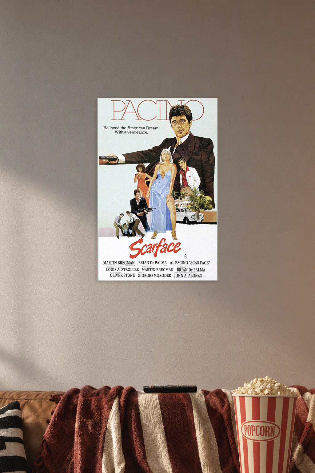 Scarface Al Pacino Movie Poster in a cozy movie room above a brown sofa with popcorn.