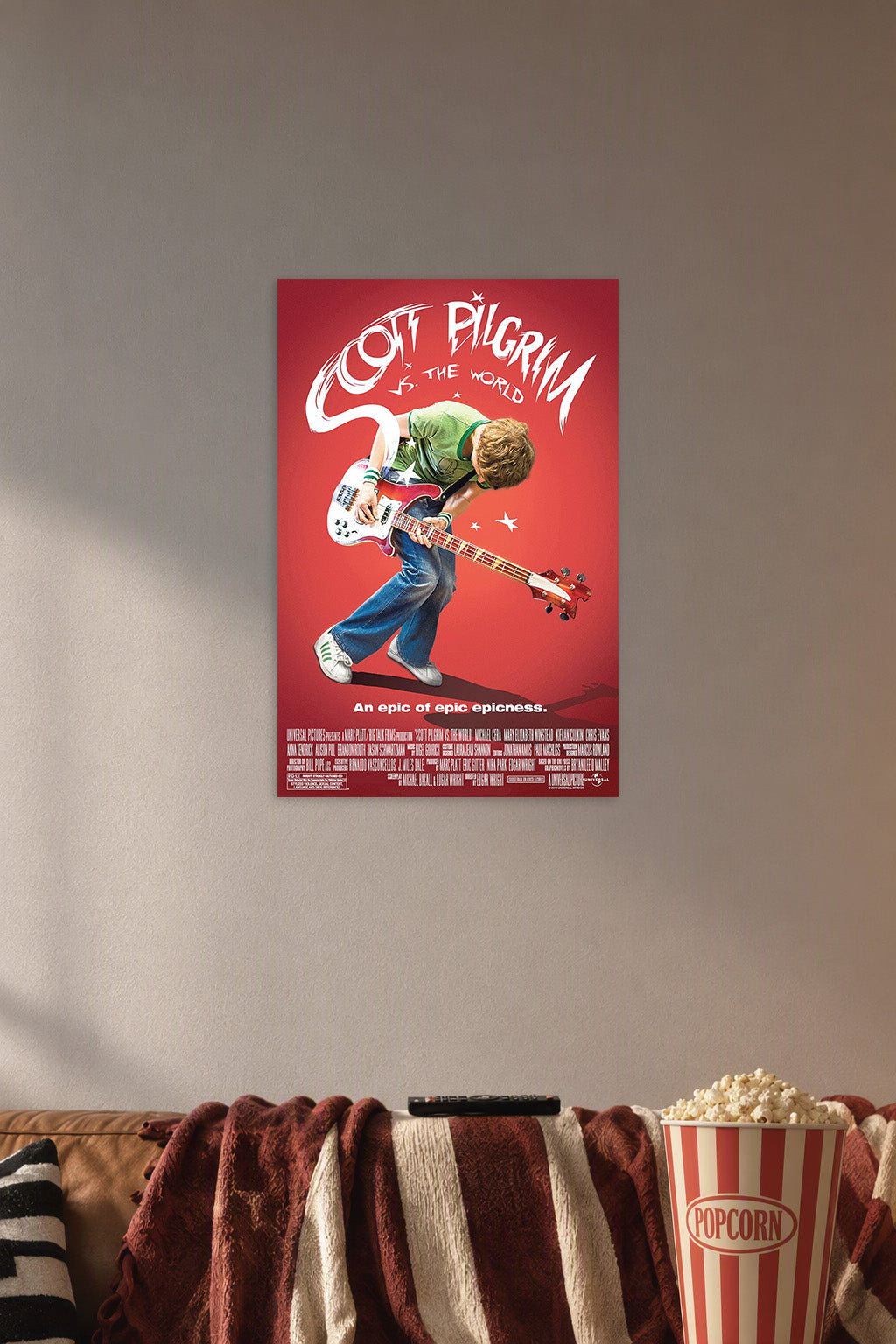 Scott Pilgrim vs. The World Movie Poster in a cozy movie room above a brown sofa with popcorn.