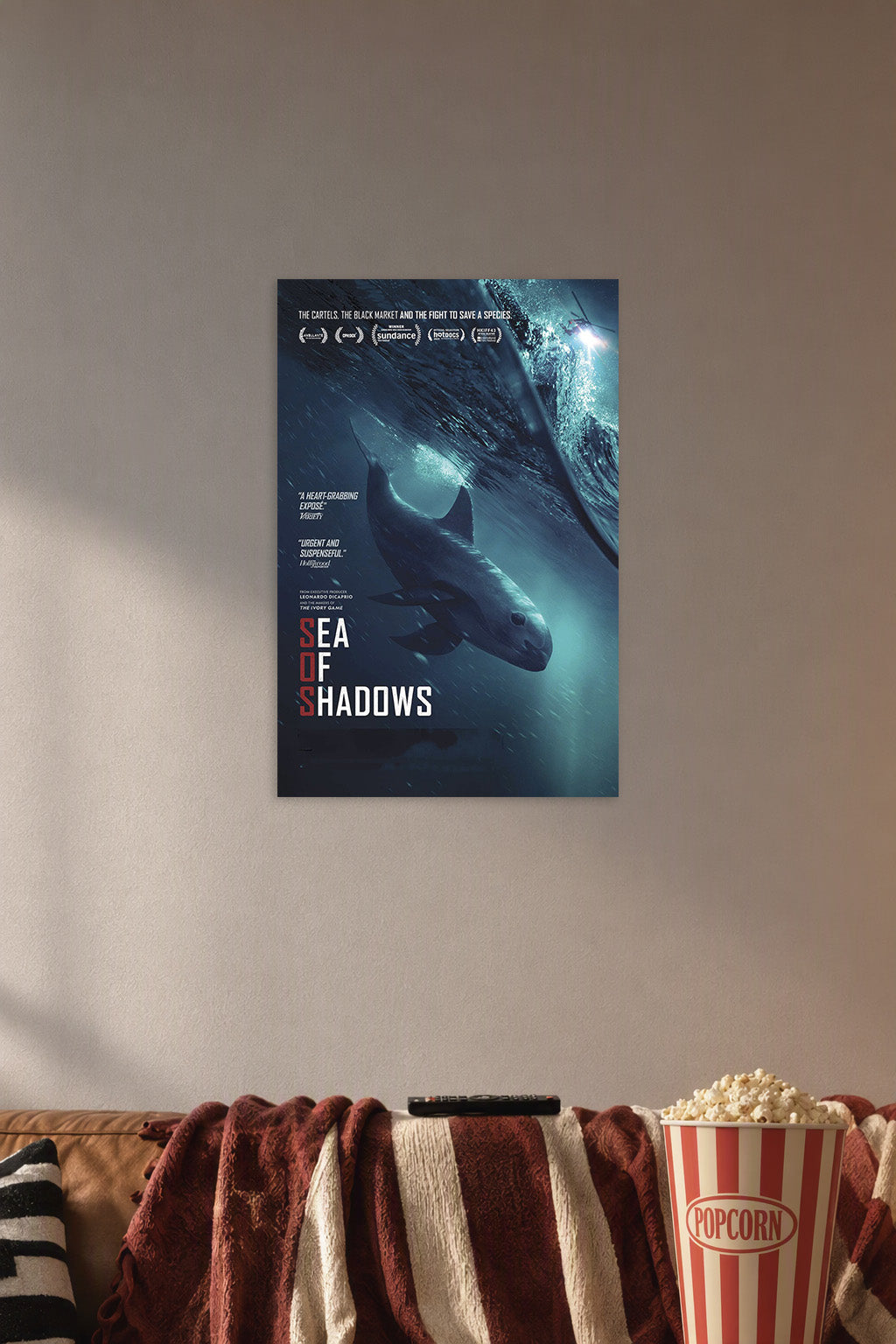 Sea of Shadows Vaquita in a cozy movie room above a brown sofa with popcorn.