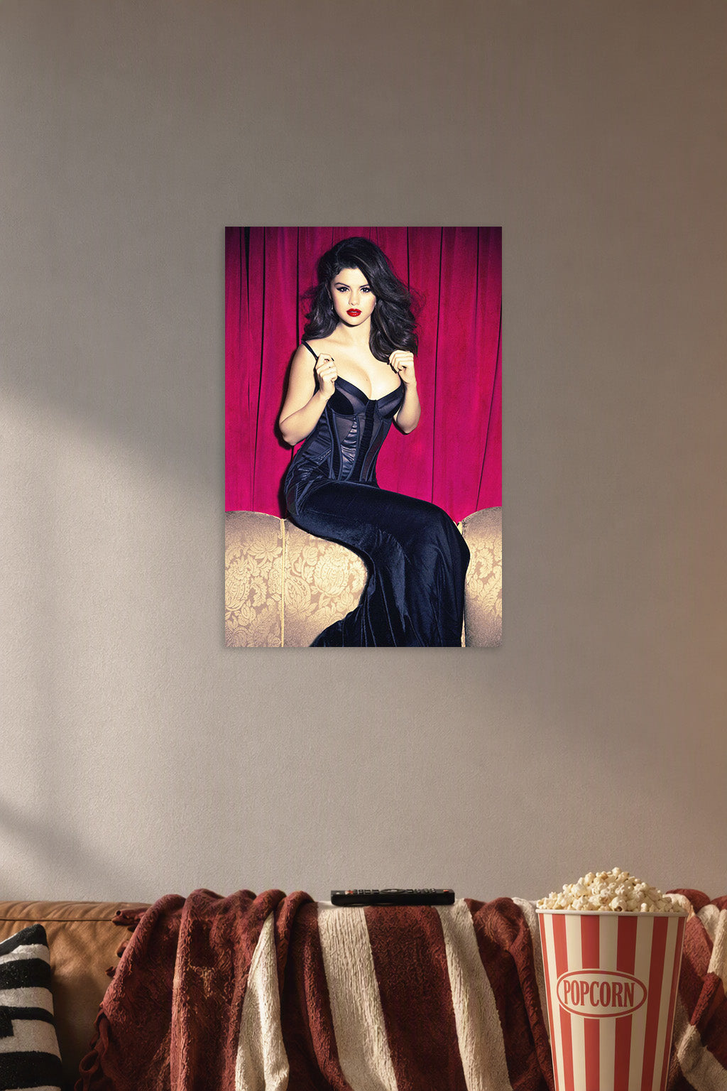 Selena Gomez in a cozy movie room above a brown sofa with popcorn.