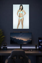 Selena Gomez in a gaming desk setup above a monitor.