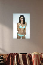 Selena Gomez in a cozy movie room above a brown sofa with popcorn.