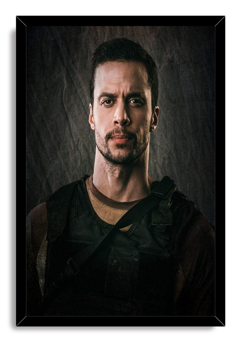 Tactical man framed wall art print features a focused bearded figure in a black tactical vest against a charcoal textured background.