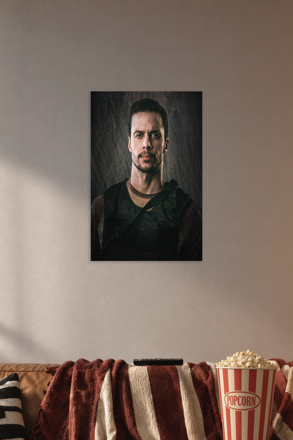 Serious Man in Tactical Gear in a cozy movie room above a brown sofa with popcorn.