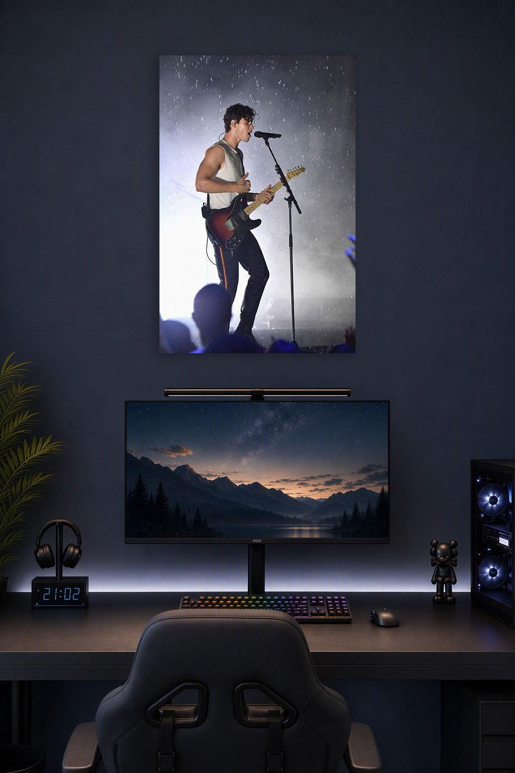 Shawn Mendes in a gaming desk setup above a monitor.