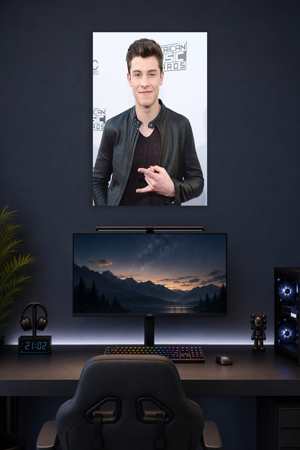Shawn Mendes in a gaming desk setup above a monitor.