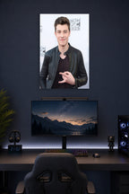 Shawn Mendes in a gaming desk setup above a monitor.