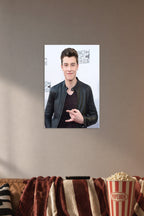 Shawn Mendes in a cozy movie room above a brown sofa with popcorn.