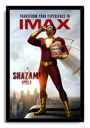 Shazam framed wall art print features the red-suited hero holding popcorn and a drink, with a cloudy city backdrop and black frame.