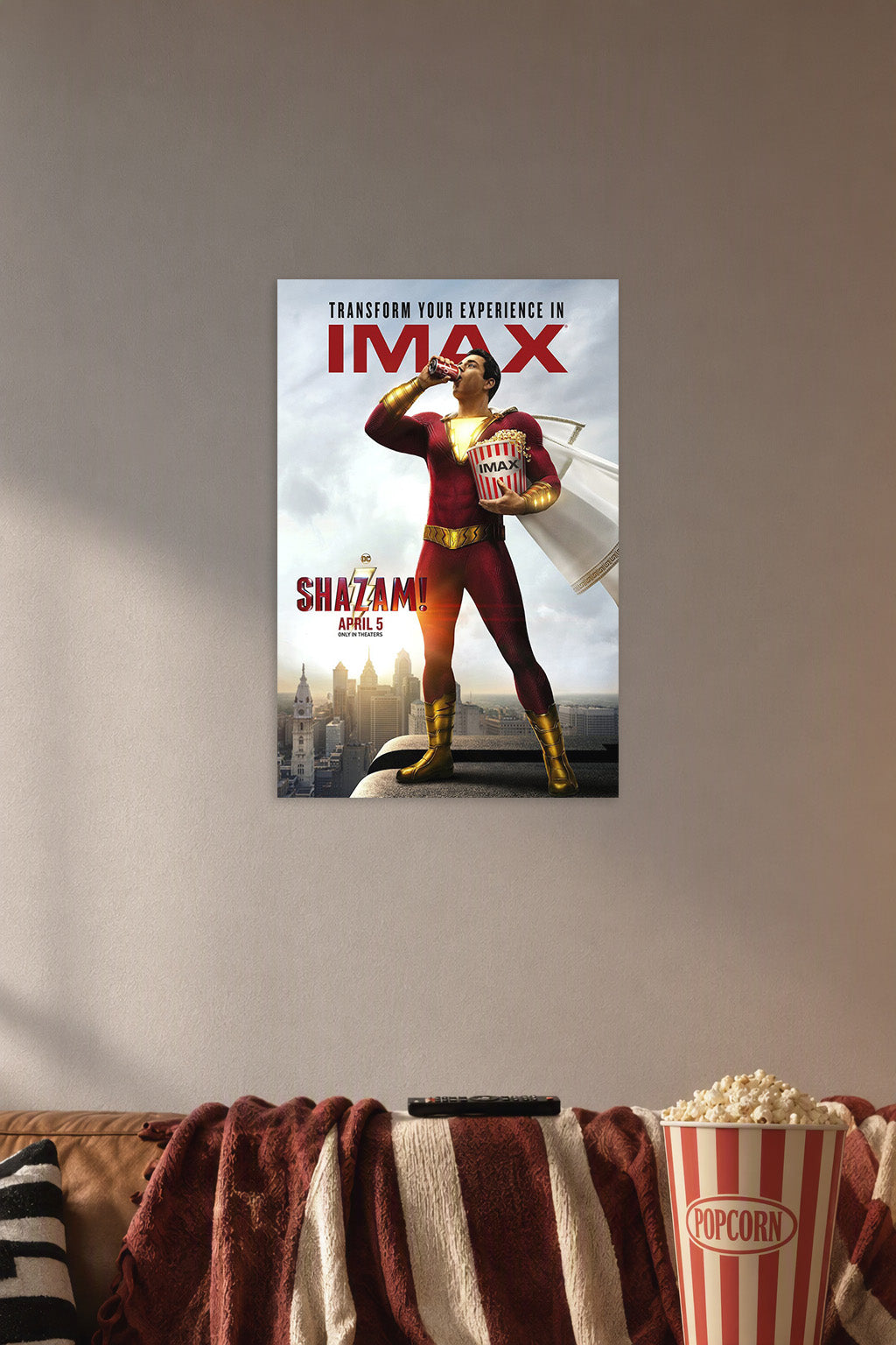 Shazam Movie Poster in a cozy movie room above a brown sofa with popcorn.
