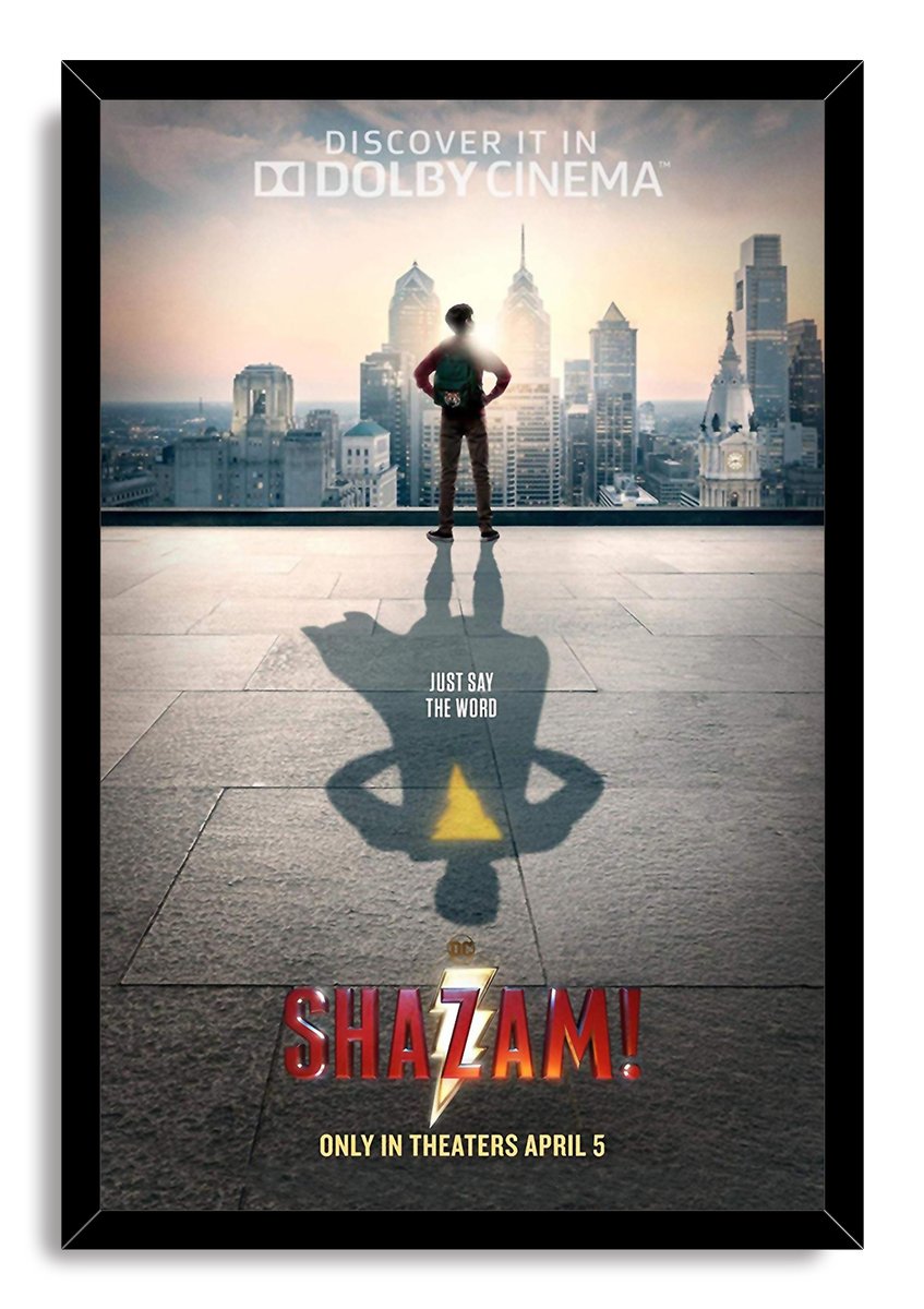 Shazam movie poster wall art print in a black frame, featuring a boy, city skyline, and superhero shadow with yellow bolt.