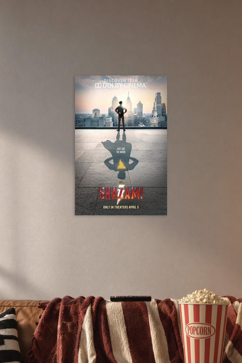 Shazam Superhero Movie in a cozy movie room above a brown sofa with popcorn.