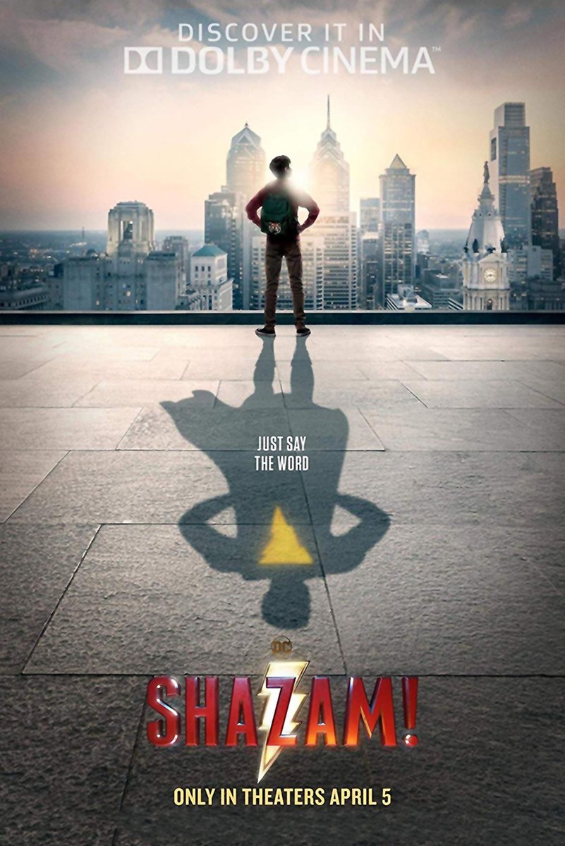 Shazam movie poster wall art print of a boy overlooking a city skyline, casting a superhero shadow with a yellow lightning bolt.