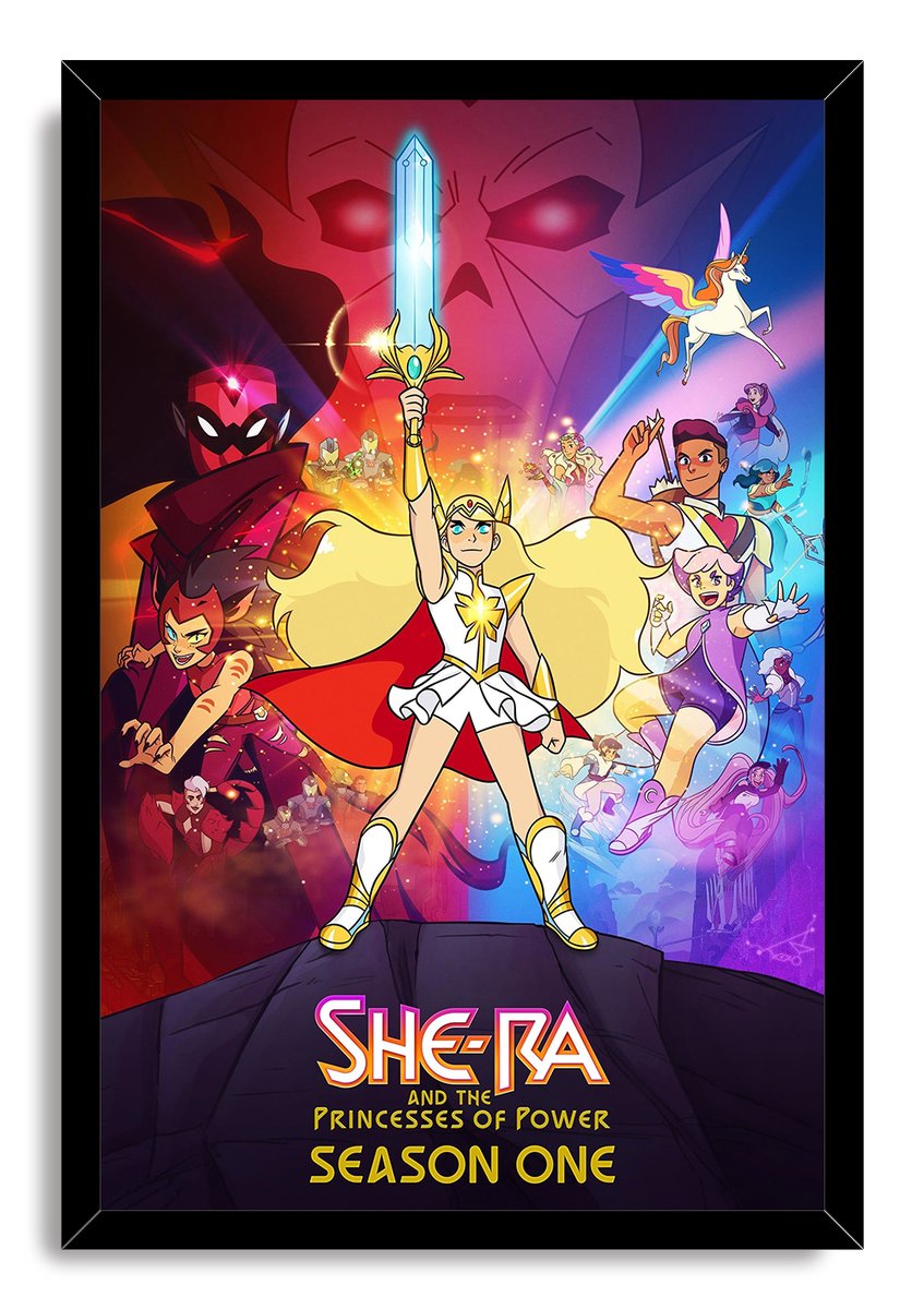She-Ra and the Princesses of Power framed wall art print with She-Ra holding her sword aloft amid colorful heroes and villains.