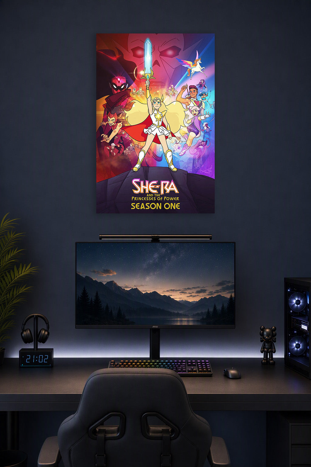 She-Ra and the Princesses of Power in a gaming desk setup above a monitor.