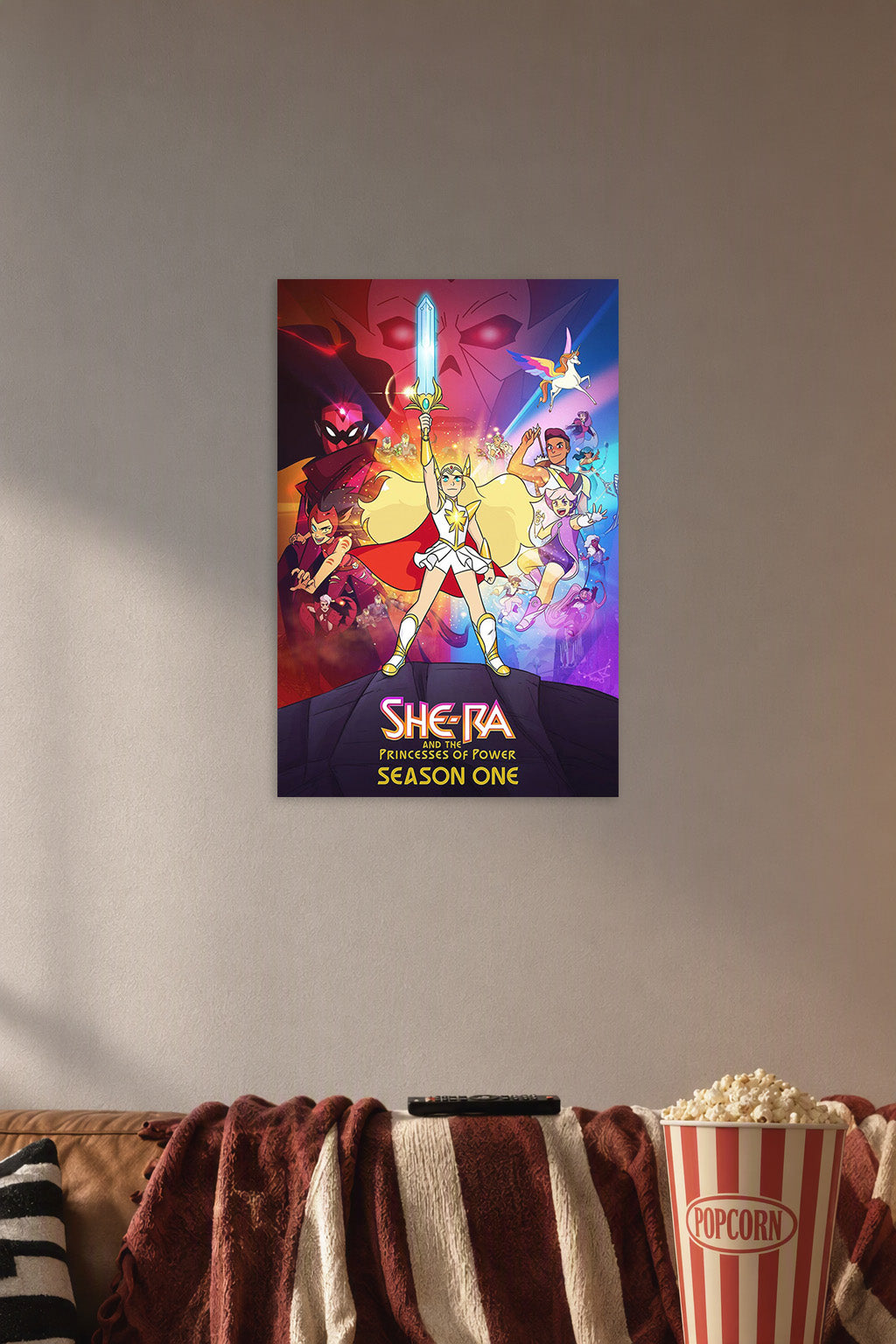 She-Ra and the Princesses of Power in a cozy movie room above a brown sofa with popcorn.