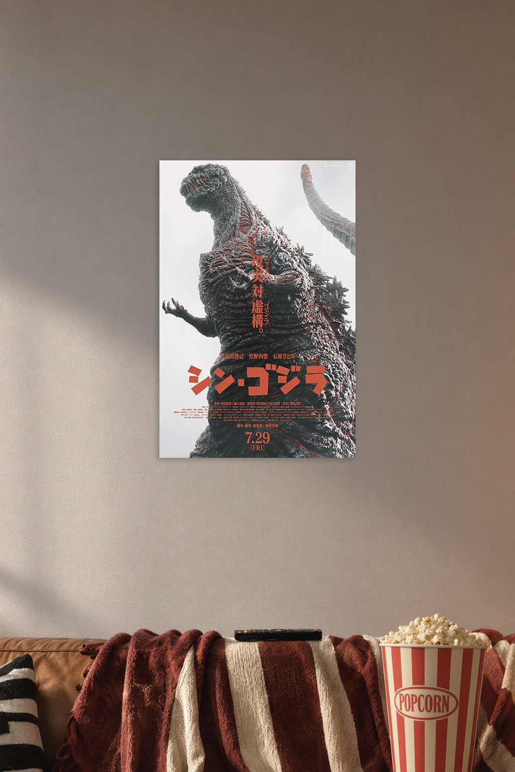 Shin Godzilla in a cozy movie room above a brown sofa with popcorn.